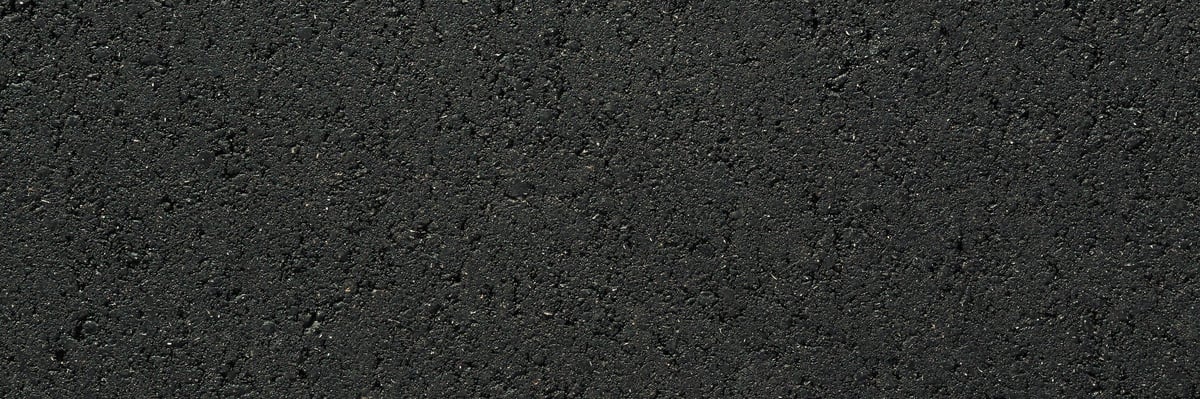 New dark black asphalt background closeup top down view
